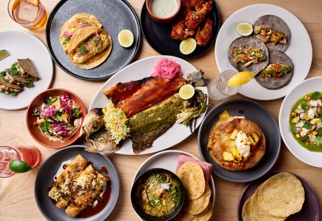 Overhead view of assorted plated dishes featuring fine dining presentations, seasonal ingredients, sauces, and shared plates at a Raleigh restaurant table.