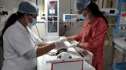 Infant Interred Living in India Struggles for Her Life